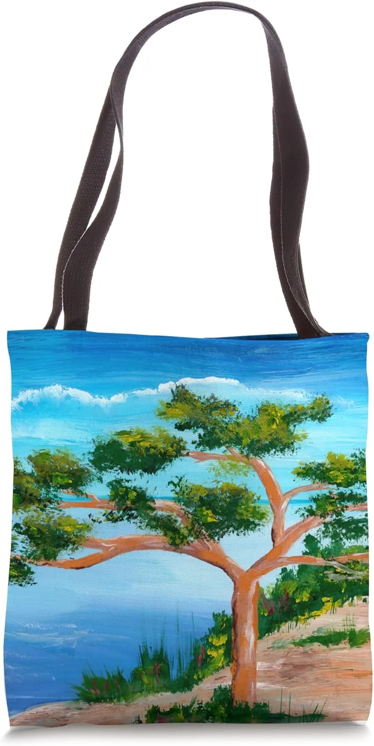 Solitary pine tree at the beach in coastal landscape Tote Bag